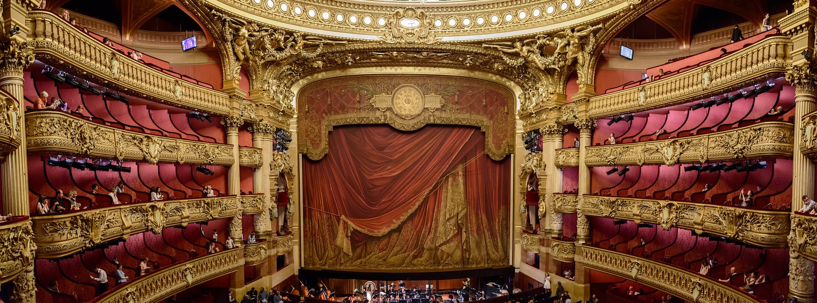 The richly decorated interior and stage of a historic opera house